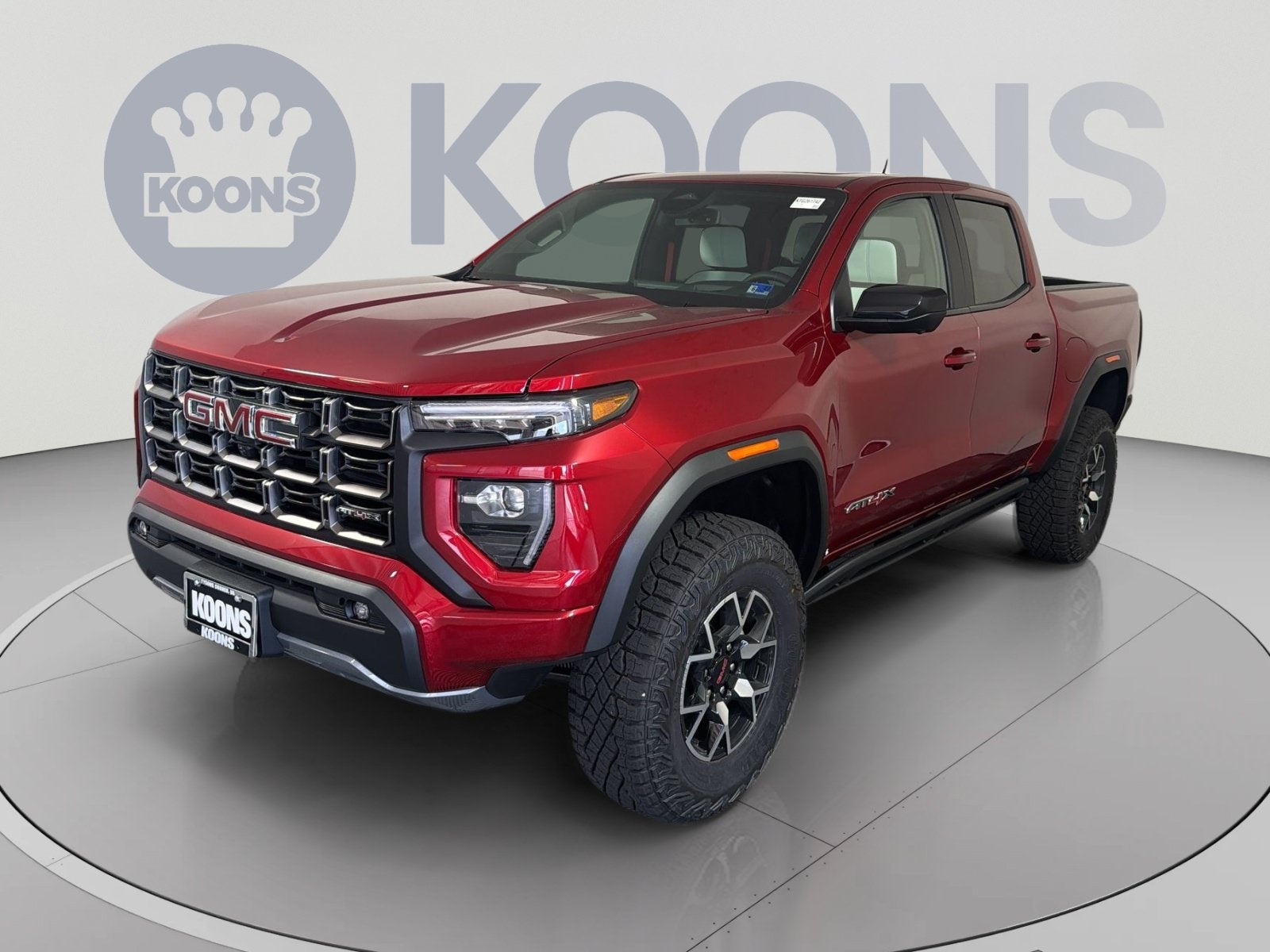 2026 GMC Canyon AT4X in Volcanic Red Tintcoat — front three-quarter view