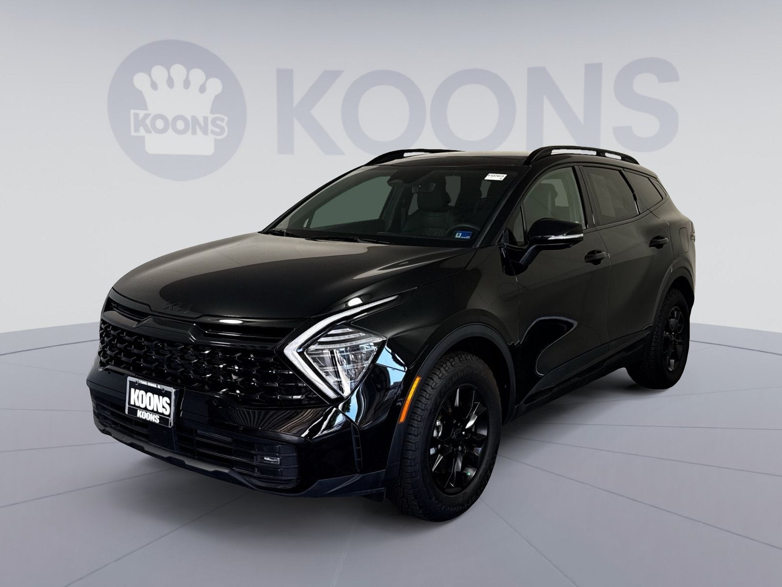2025 Kia Sportage X-Pro Prestige in Ebony Black — front three-quarter view