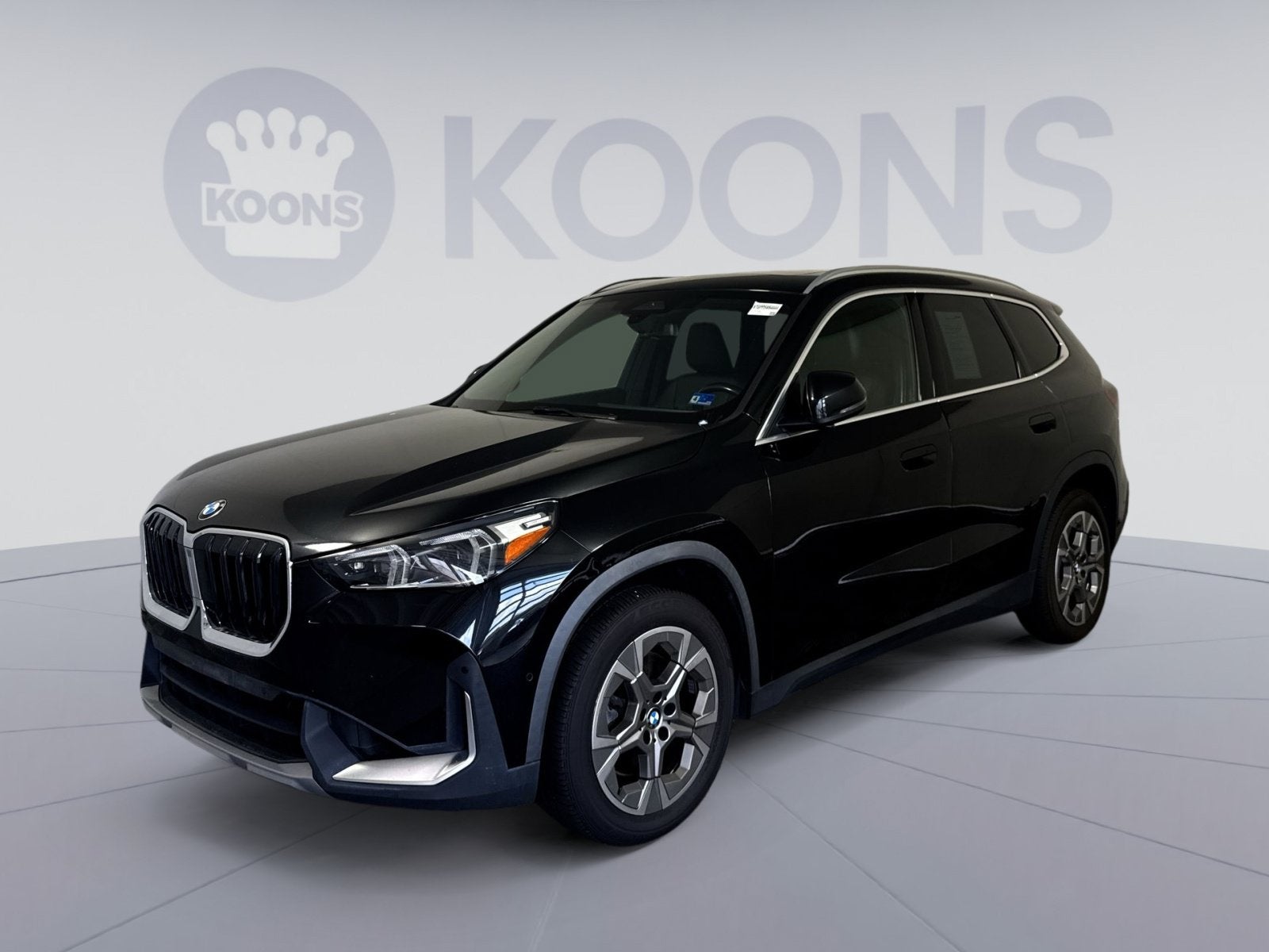 2023 BMW X1 xDrive28i in Black Sapphire Metallic — front three-quarter view